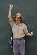 John Trager holds a long inflorescence from a small potted specimen.